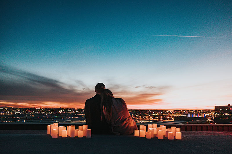unmarried-couple-sitting-looking-at-night-sky-